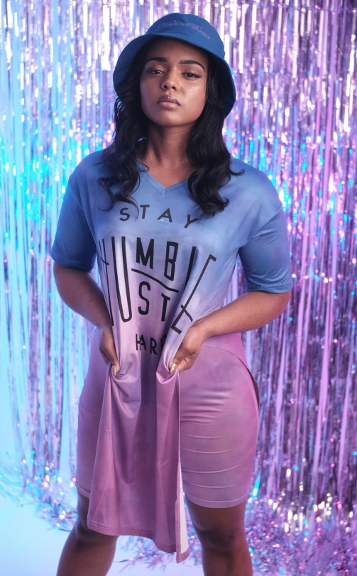 a woman wearing purple in front of a glitter background