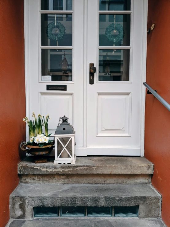 two white doors are open in an orange house