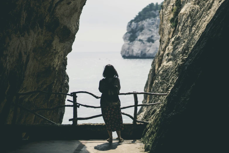 a person on a stairway overlooking a body of water