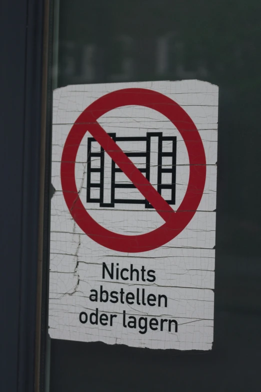 a no parking sign is posted on a glass window