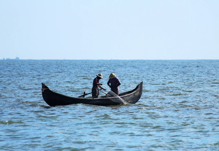 the two people are in the small boat in the water