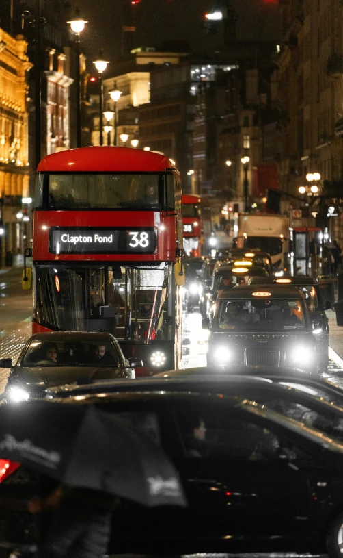 a very busy street with lots of cars and buses at night