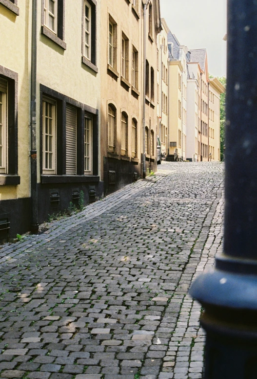 an old street with cobblestone and buildings on both sides