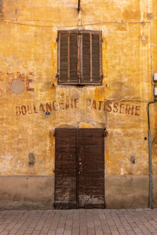 an old building has two doors and windows