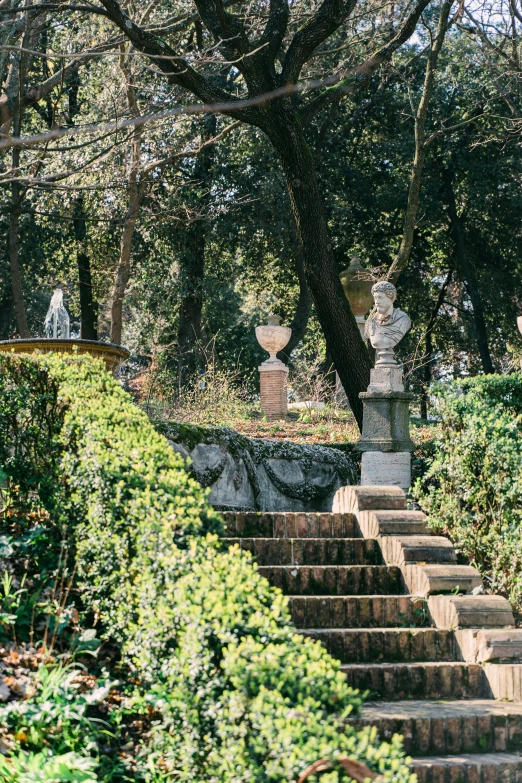 the stairs lead down to a small stone monument