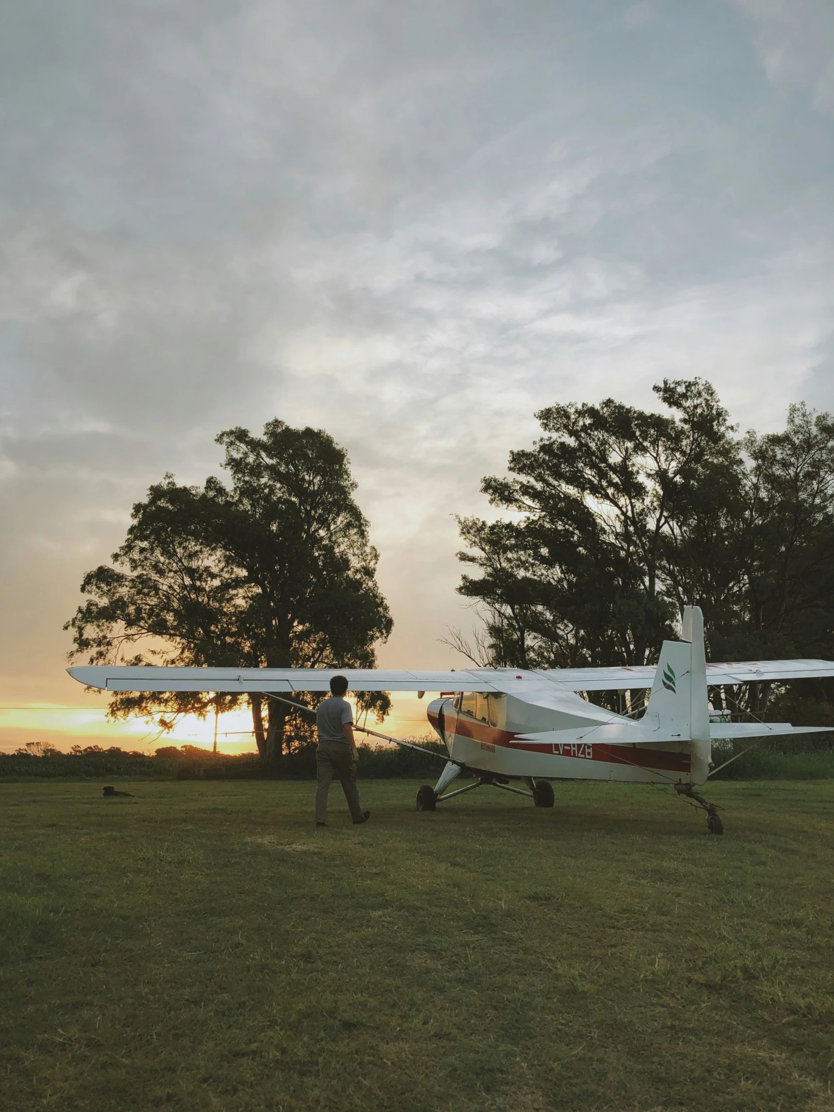 a man standing next to a small airplane