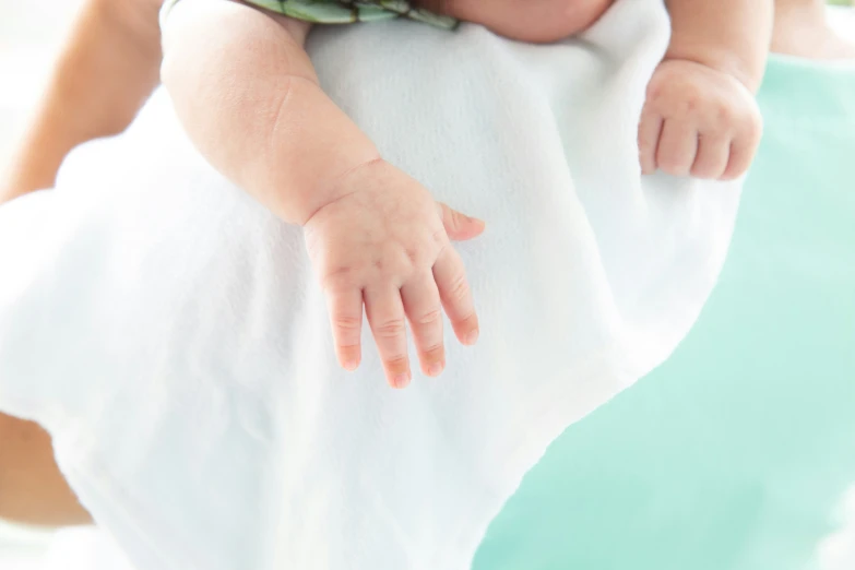 a young baby is being held in the air