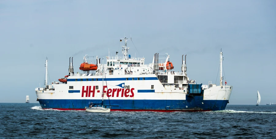 a large boat in the ocean with boats around it