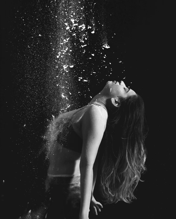 a woman is floating under water while her hair is splashing off the floor