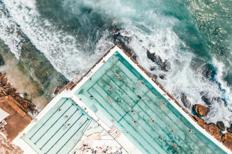 an aerial view shows an empty swimming pool near the beach