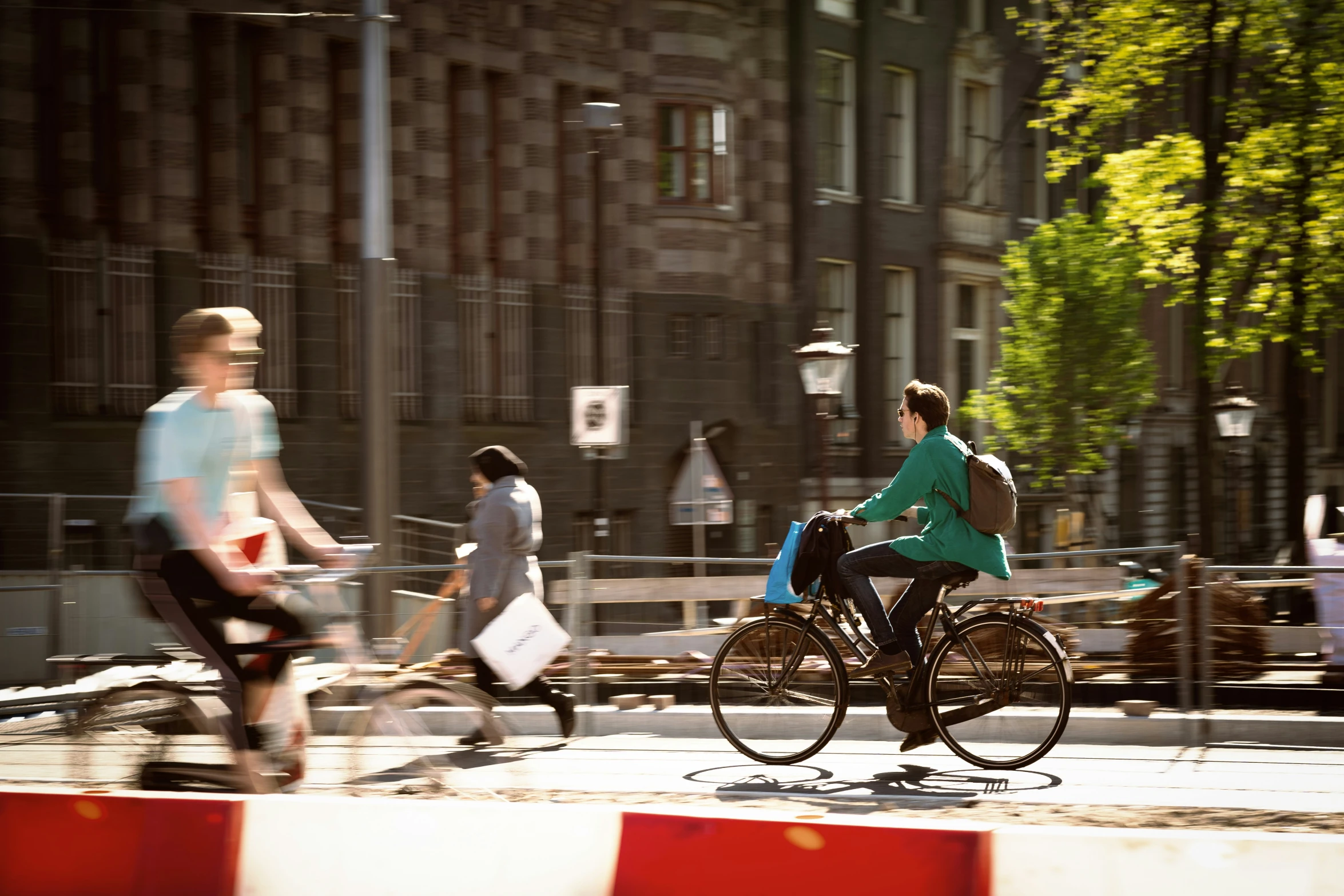 three people riding their bikes in a bike race