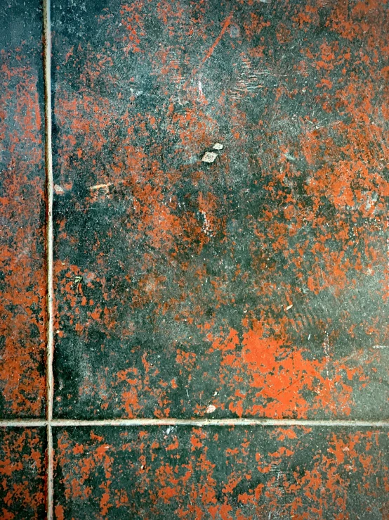 a rusted grungy wall with a large knife in the center