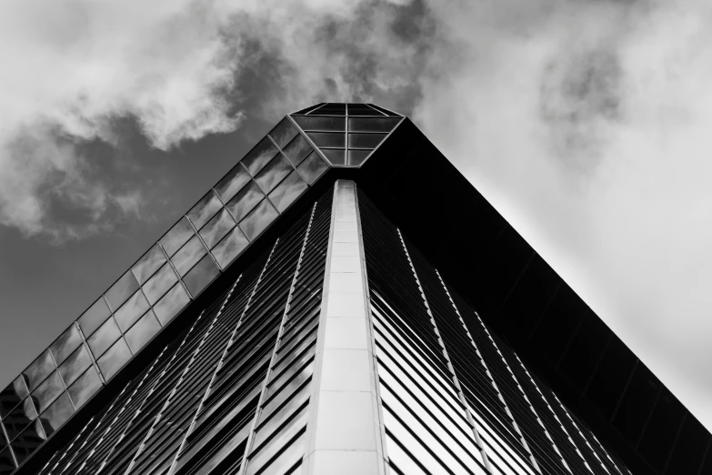 an office building with metal grating on the side and sky in background