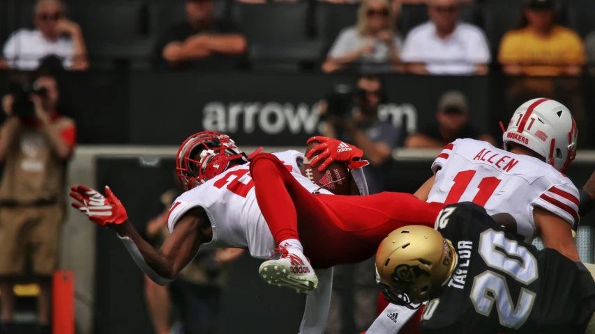 some men wearing helmets in the air playing a game