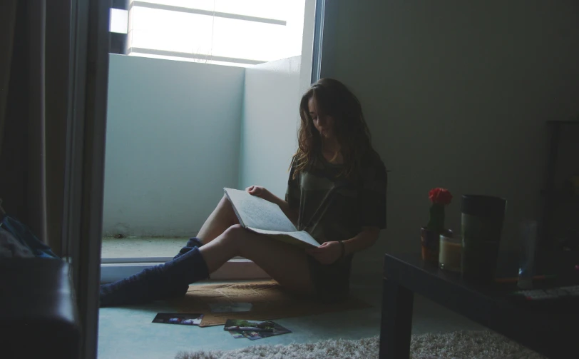 a woman sits down and reading a book