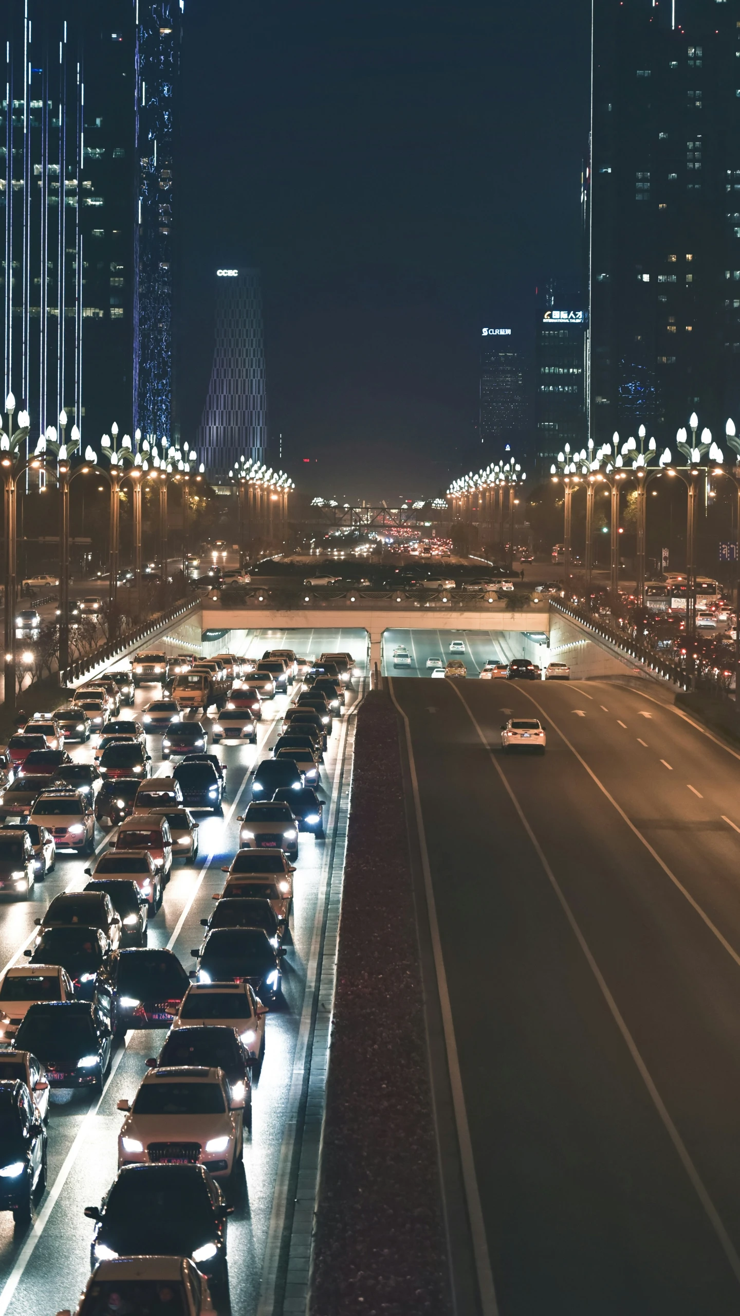 a long line of cars travel on the street