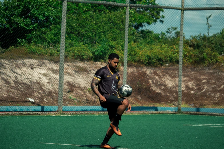 a man running with a soccer ball in his hand