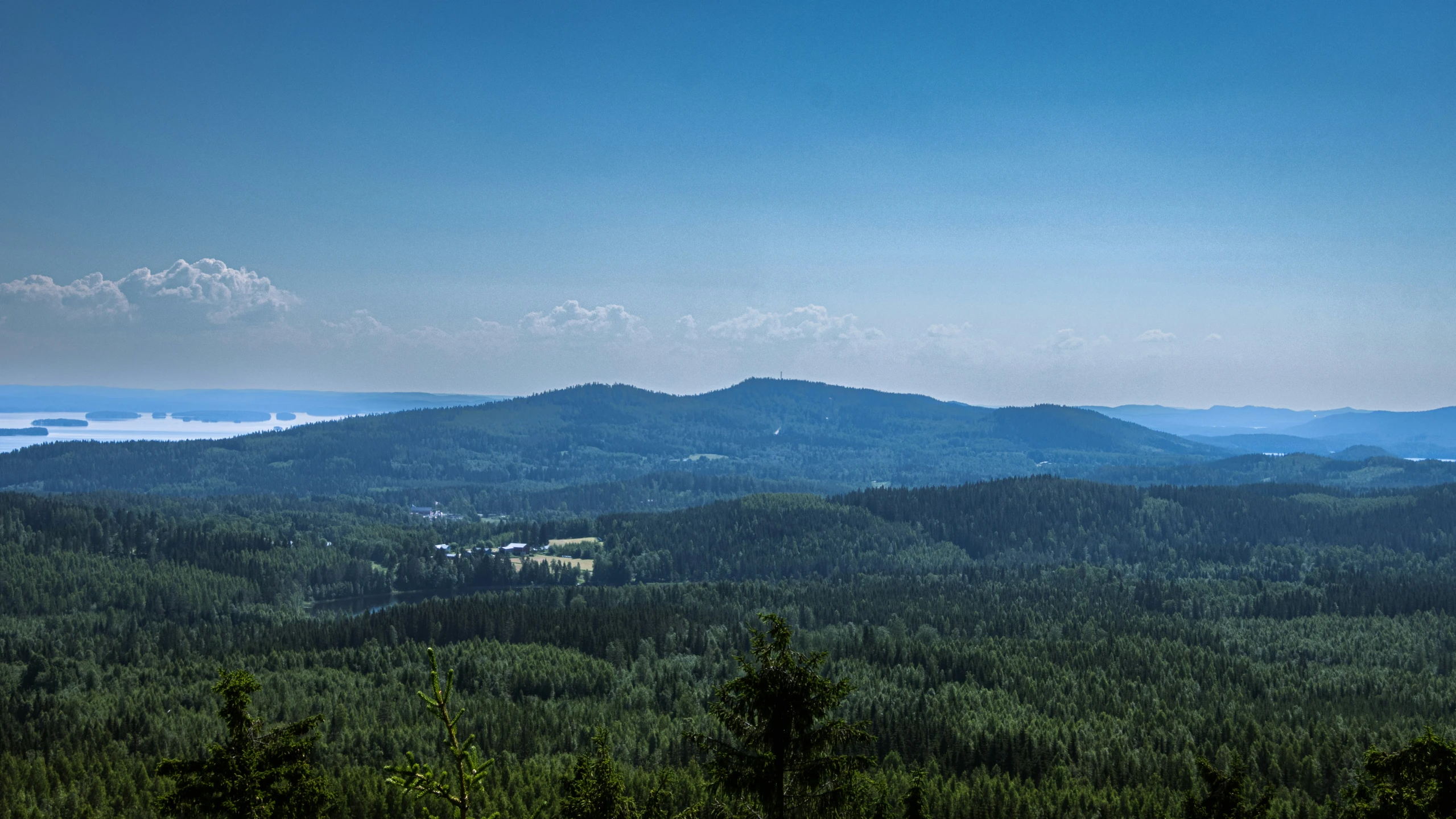 a scenic view of the mountains, water and trees