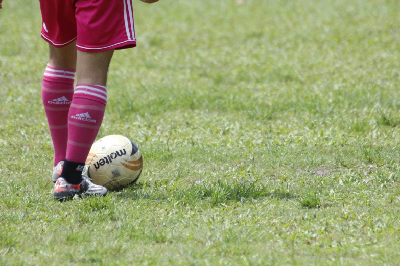 a person wearing socks and a soccer ball on a field