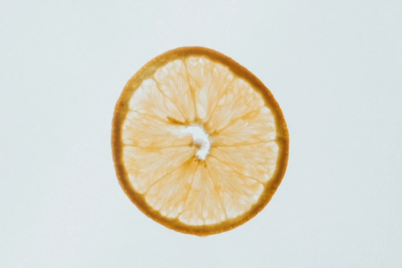 an orange slice being dropped into the air
