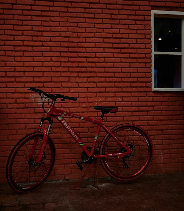 a bike is leaning against a brick wall