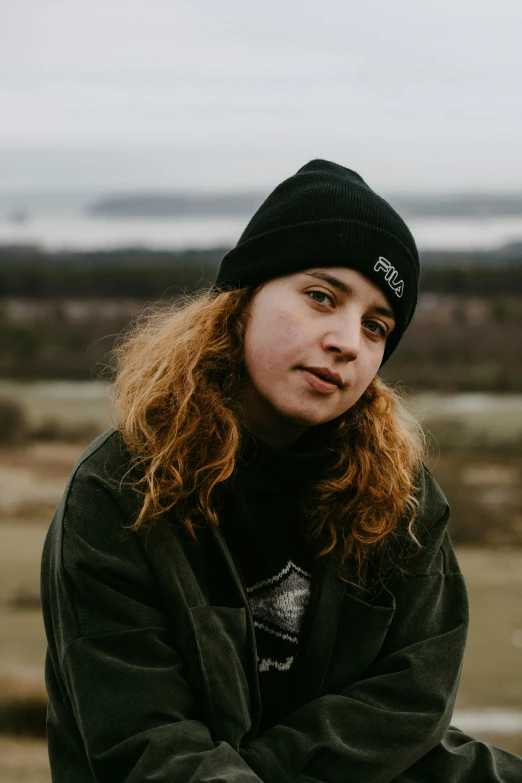 a young woman with long hair wearing a beanie