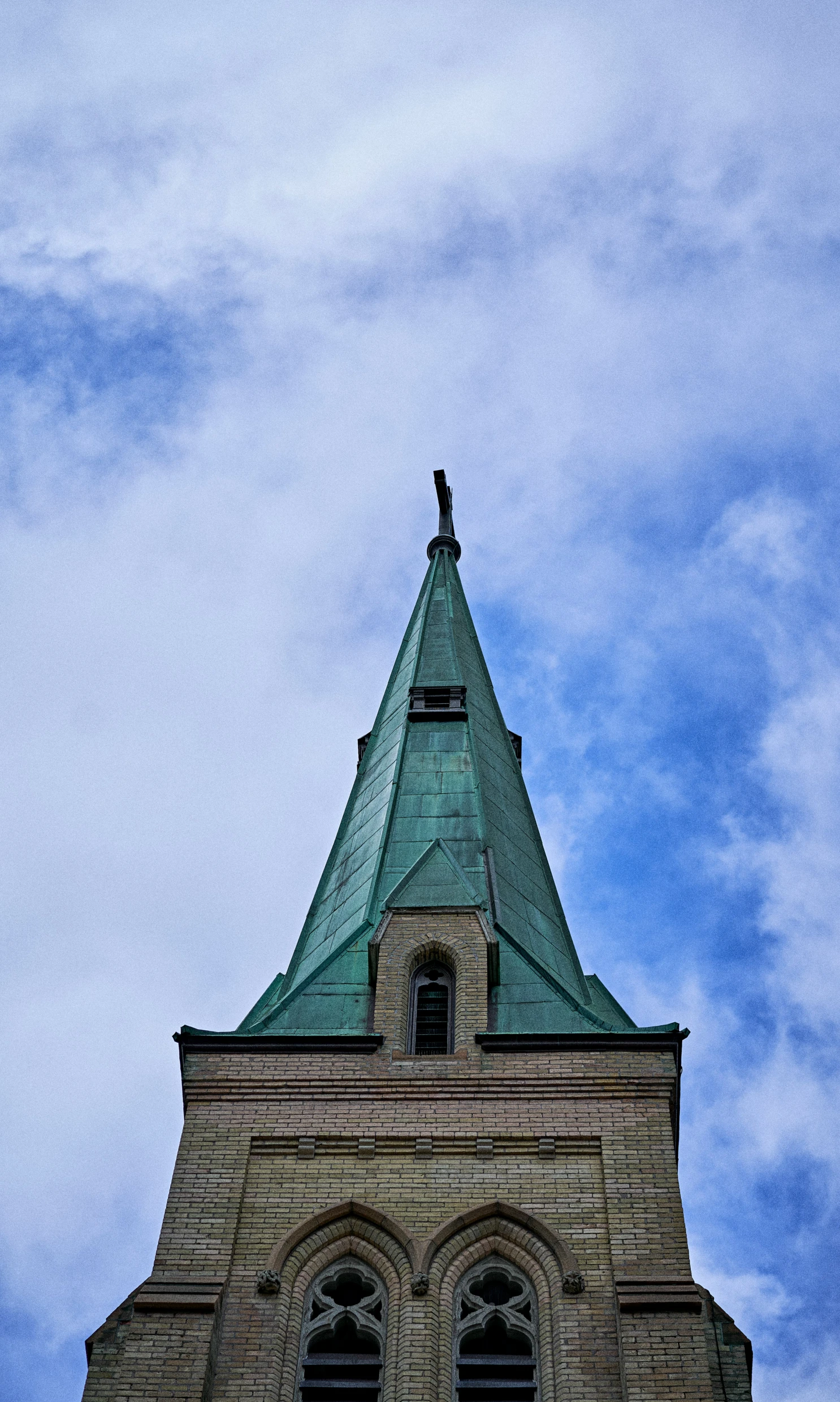 an ornate clock tower with a weather vane