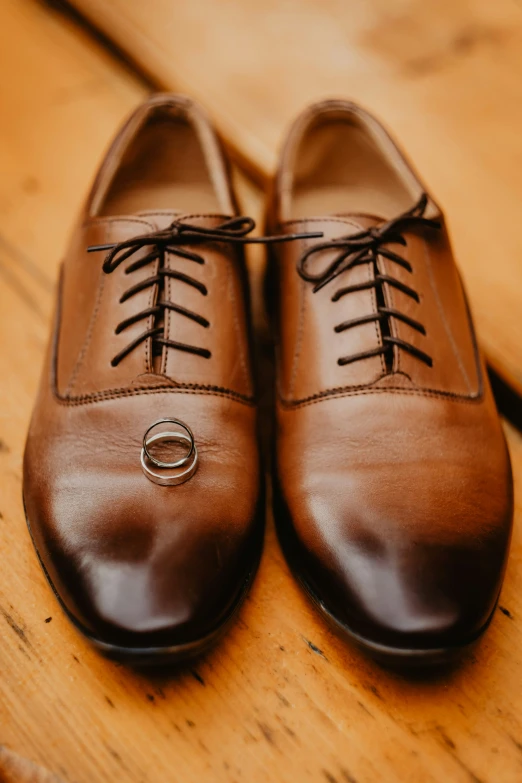 a pair of shoes sit on top of a wooden table