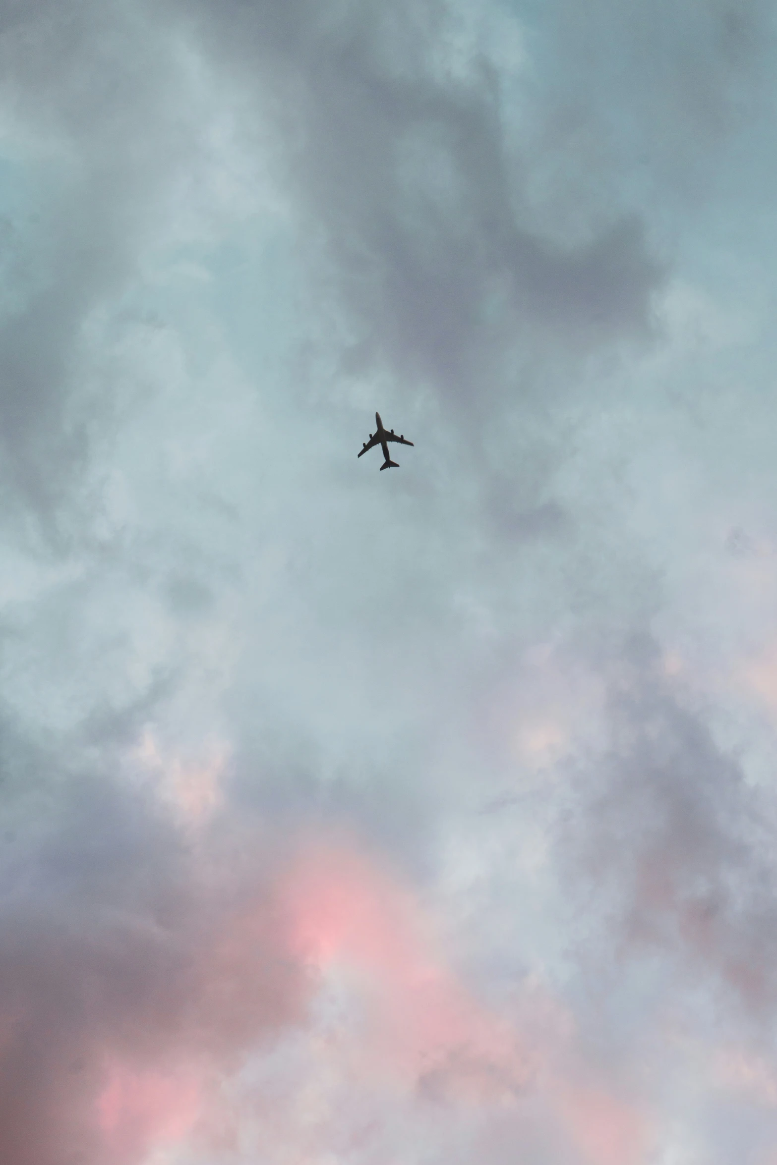 an airplane is flying through the cloudy sky