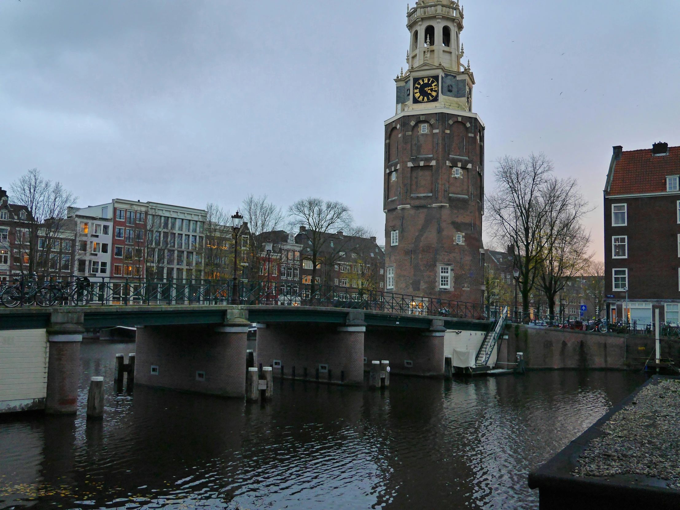 a clock tower that is in the middle of a canal