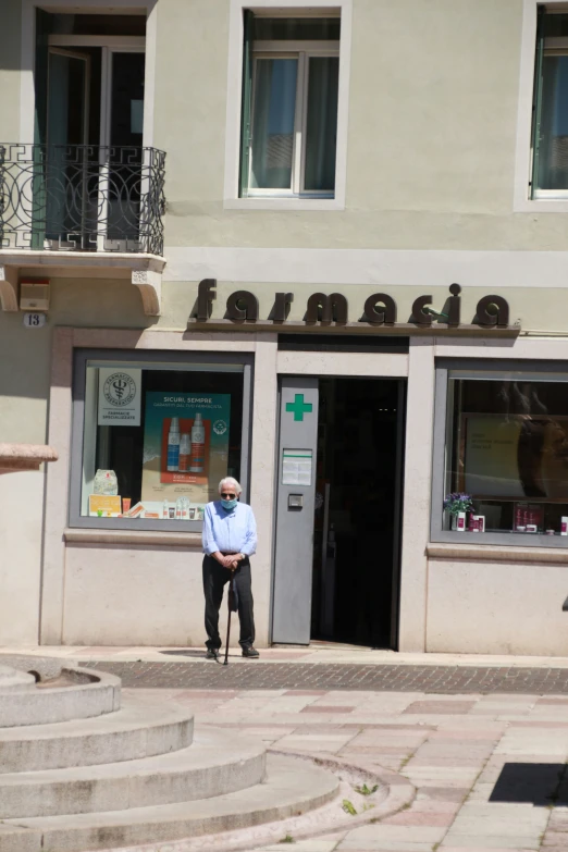 a man standing on a street corner in front of a building