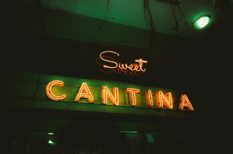 neon sign above cantinaa restaurant in the dark