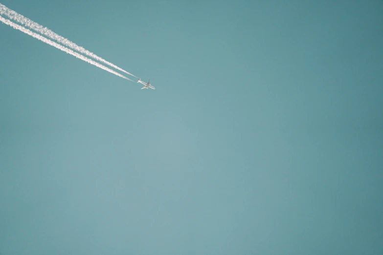 two planes flying in the air above the clouds