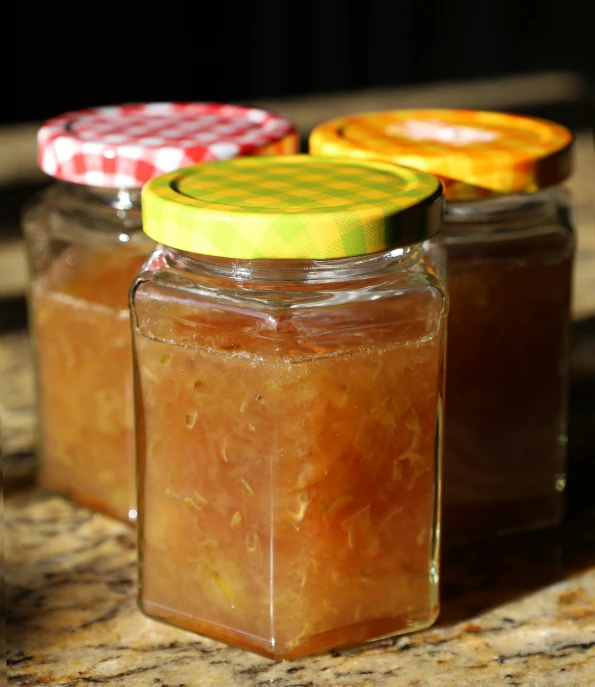 a jar of canned oranges sitting on top of a table