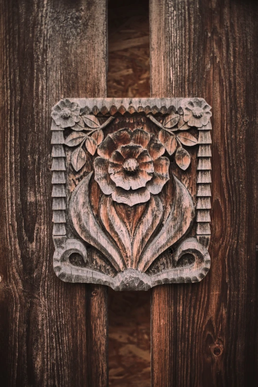 wooden planks decorated with a carving on the front of a building