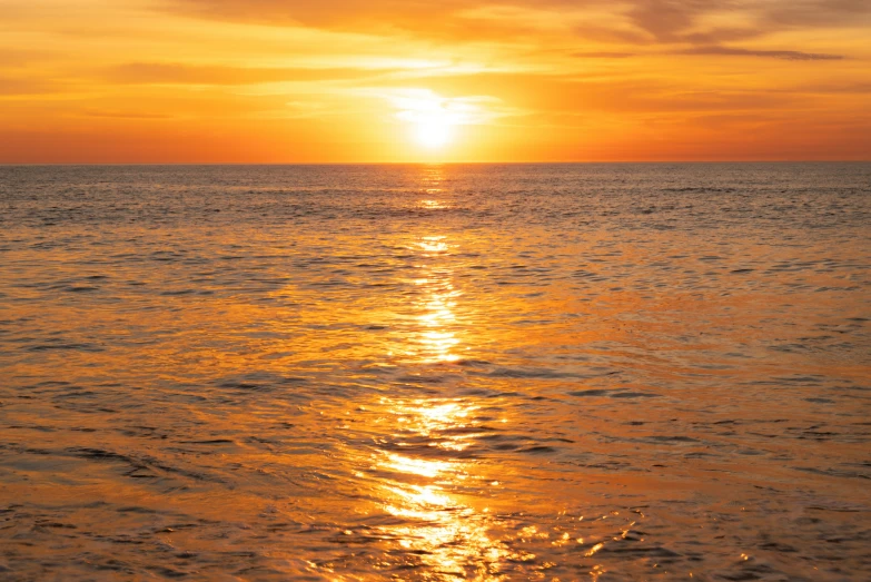 sunset over the ocean, showing very bright orange colors