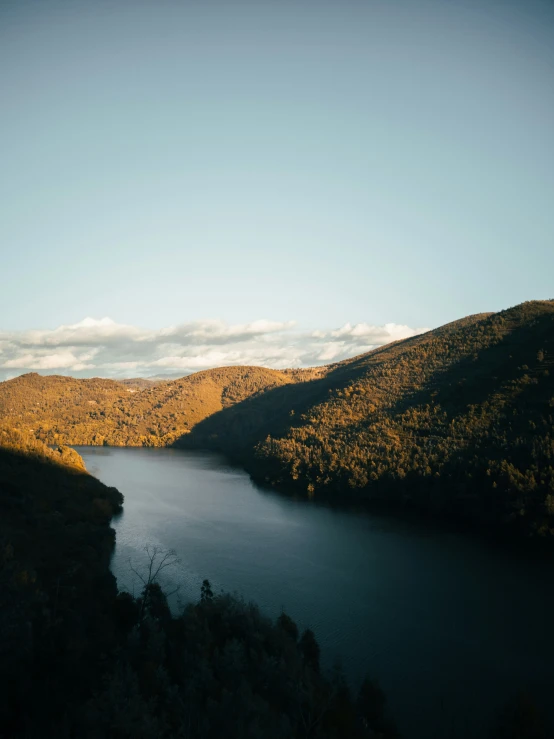 a river near a hillside in the mountains