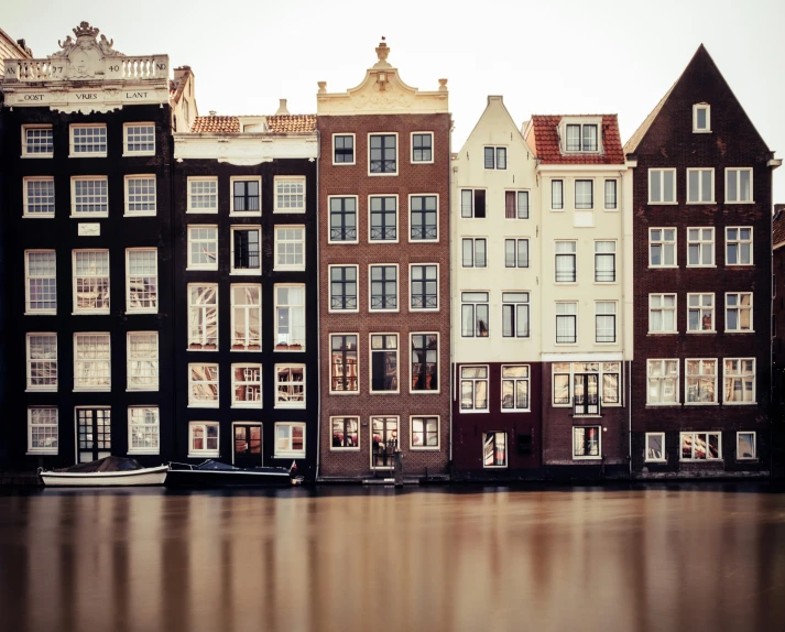 a boat in a body of water next to some buildings