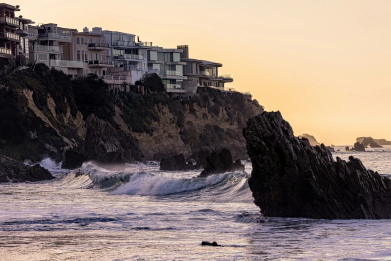 houses on the cliff above the ocean waves