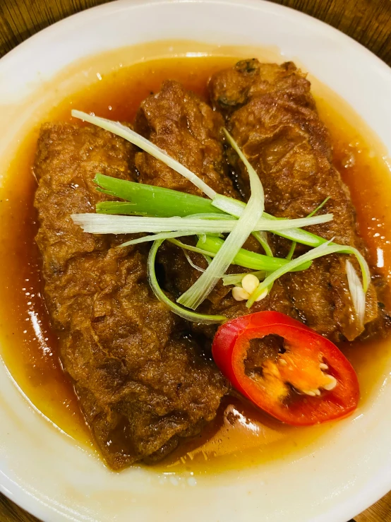 food served with vegetables in the white bowl