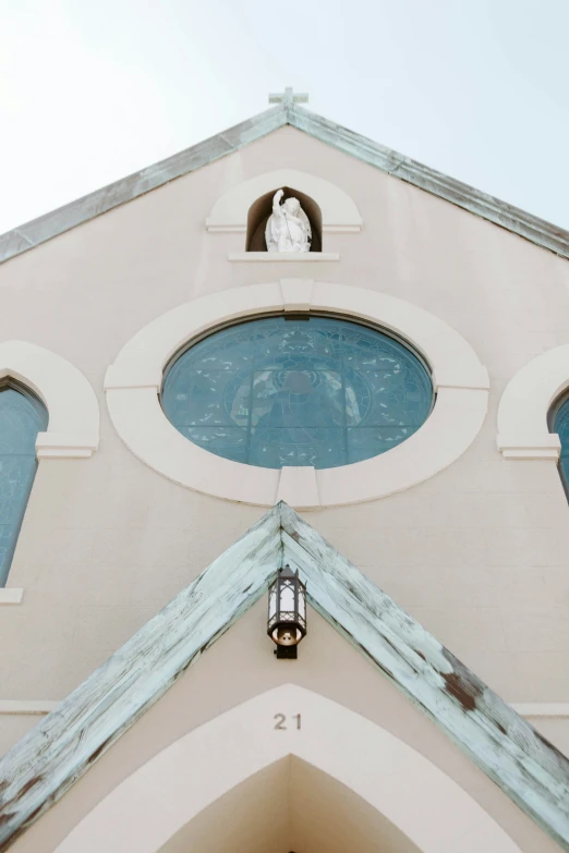 an old church with a clock and large windows