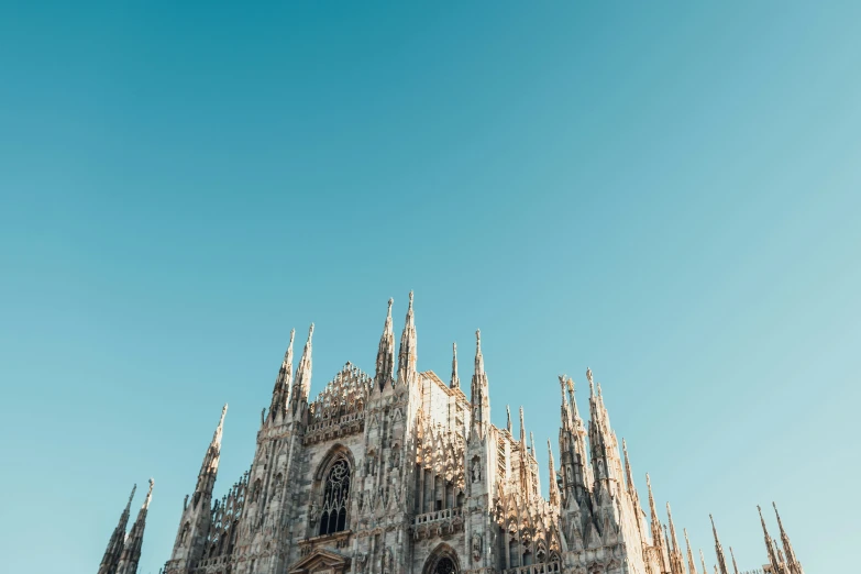 a cathedral with multiple steeples on a sunny day