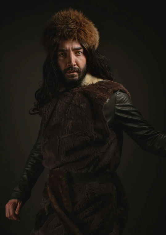 man in fur hat and leather coat in studio s