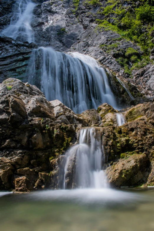 a water fall with some small streams coming off the side