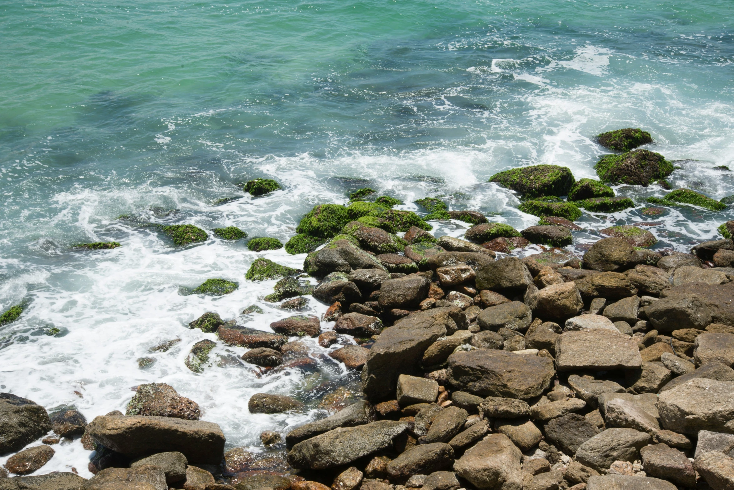 rocks and water under the waves near shore