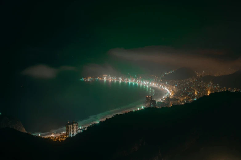 a city and lake are illuminated at night