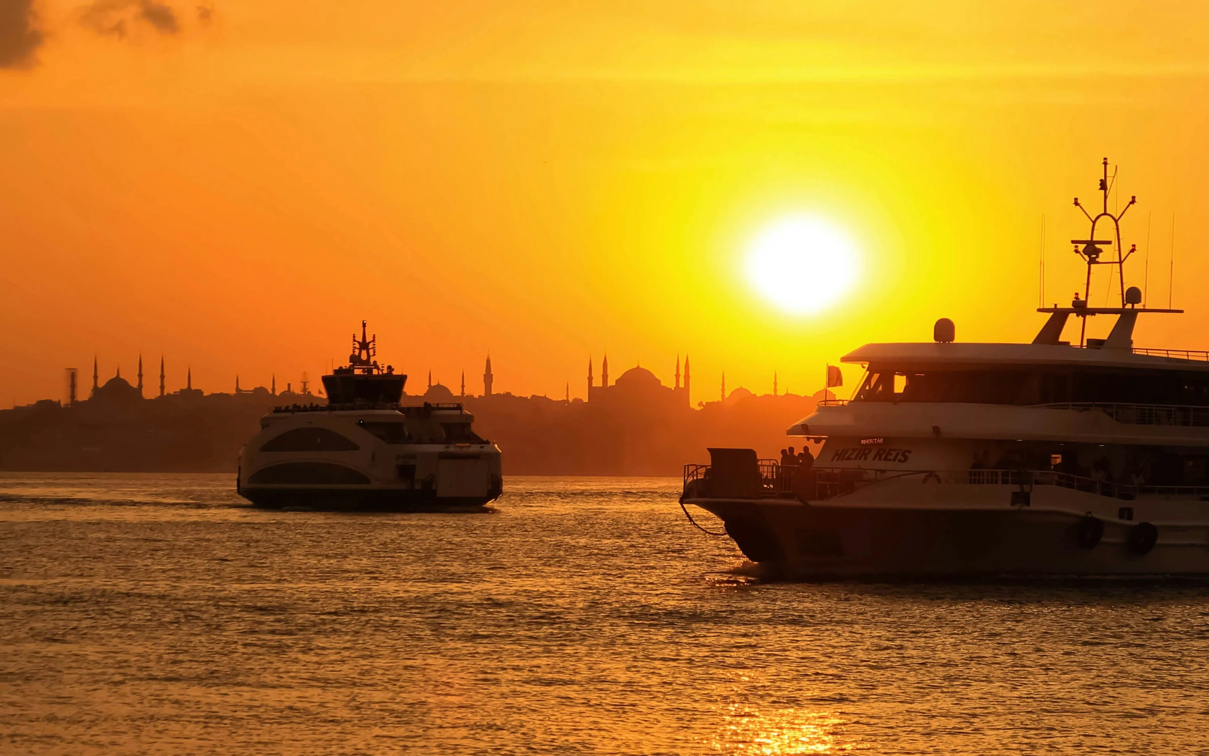 two boats are docked as the sun sets