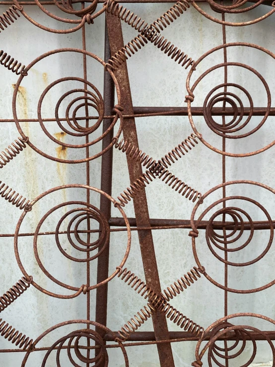 an up close picture of rusted metal with spiral design