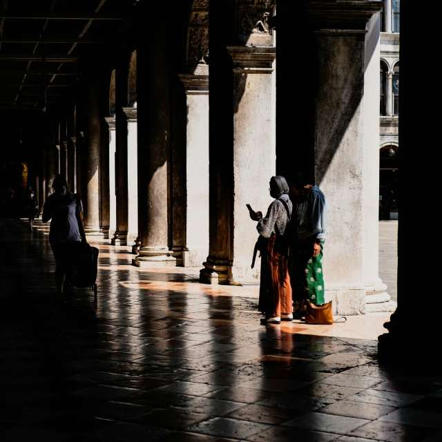 people in old fashion clothing standing in a building