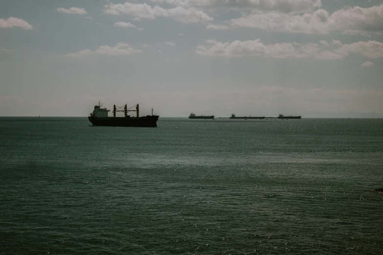 ships on the water with blue sky and clouds